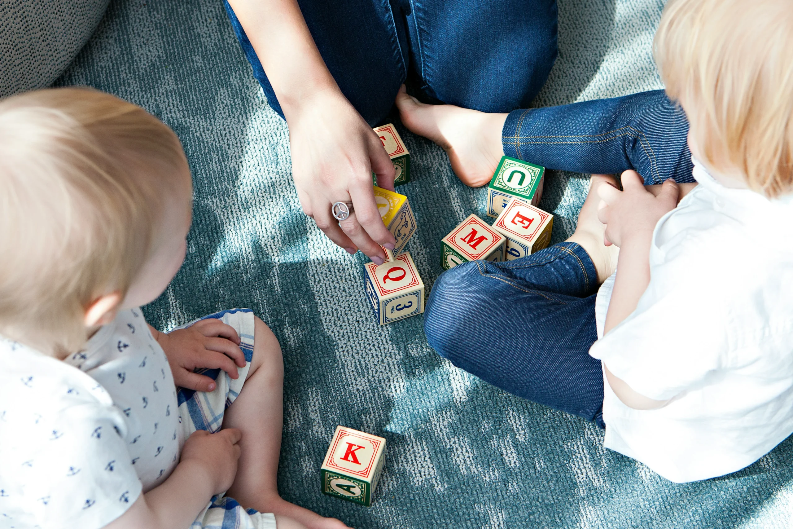 Children playing with blocks on carpet