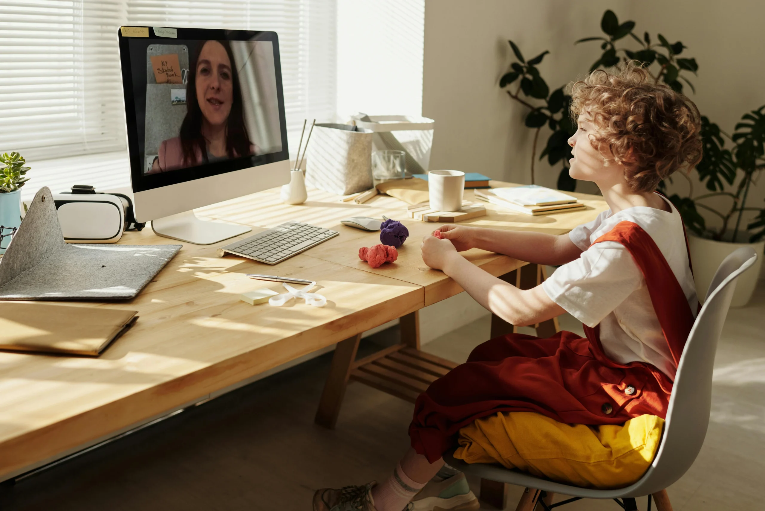 child on video call with speech therapist